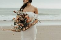 a simple yet very romantic off the shoulder wedding dress with a train for a boho feel