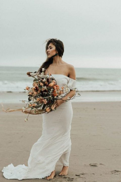 a simple yet very romantic off the shoulder wedding dress with a train for a boho feel