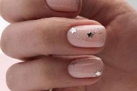 a starry bridal manicure in nude, with silver glitter and large nails is a lovely and fresh idea for a celestial wedding