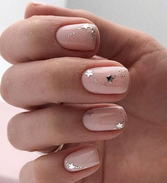 a starry bridal manicure in nude, with silver glitter and large nails is a lovely and fresh idea for a celestial wedding