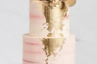 a striped pink wedding cake with gold foil decor, with white and pink blooms, gilded and usual leaves is an elegant and stylish idea
