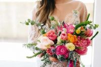 a summer wedding bouquet with pink, orange and blush flowers, greenery and colorful hanging ribbons