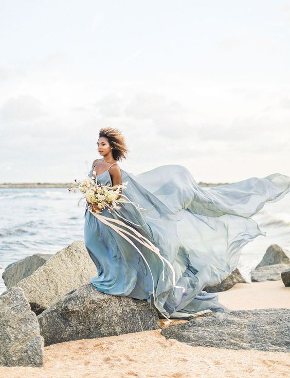 a super airy blue spaghetti strap wedding dress with a train will make a statement on any coast