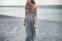 a unique mermaid-inspired wedding gown in grey, with embellishments and a train is a fantastic idea