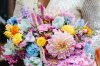 a vibrant wedding bouquet of hot pink, blush, yellow, blue and mint blooms, greenery and bright ribbon is amazing for a super bold wedding