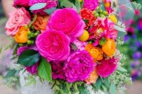 a vibrant wedding bouquet with hot pink, light pink, honey yellow, billy balls, greenery is a cool and bold idea