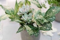 a wedding centerpiece with greenery and succulents is a chic and trendy decor idea