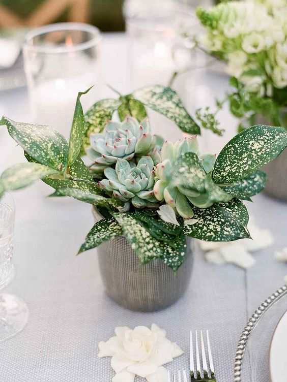a wedding centerpiece with greenery and succulents is a chic and trendy decor idea