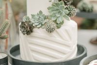 a white geometric wedding cake with succulents and cacti is a stylish idea for any modern wedding