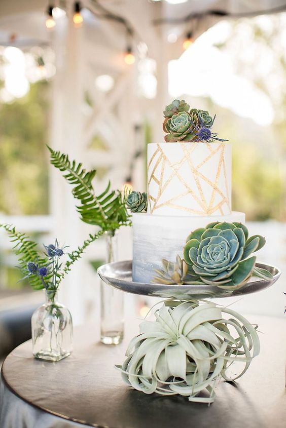 an ombre and geometric wedding cake with succulents and thistles is very chic and trendy