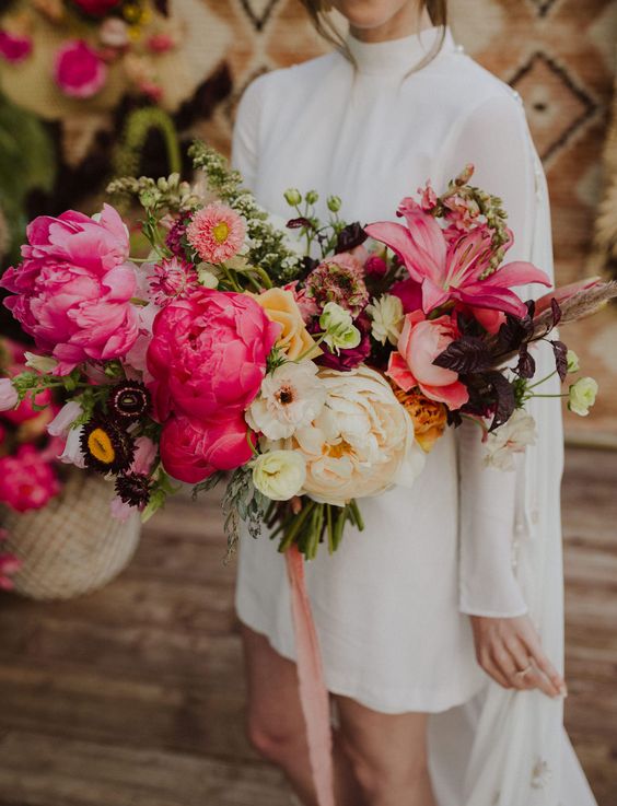 an oversized statement wedding bouquet of large pink peonies, neutral and deep purple blooms and greenery plus pink ribbon is amazing
