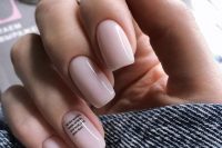 blush nails with a tiny quote on the ring finger – choose your favorite quote about love and relationships
