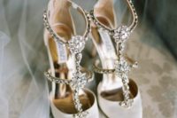 gorgeous glam white wedding shoes with fully embellished straps and heavy embellishments are a bold solution for summer
