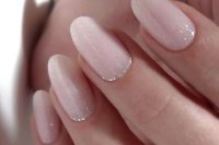 icy light pink wedding nails with silver glitter are amazing for a glam winter bridal look