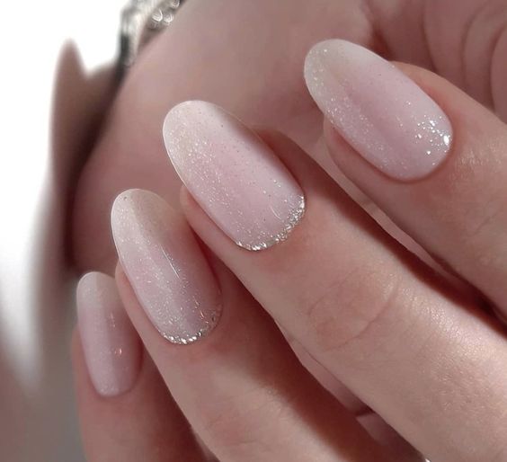 icy light pink wedding nails with silver glitter are amazing for a glam winter bridal look