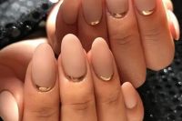 matta blush nails with glossy gold accents are like a fresh take on French manicure, with a touch of glam and chic