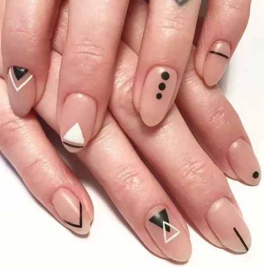 matte nude nails with white and black tribal patterns look magnificent and very bold, ideal for a boho wedding