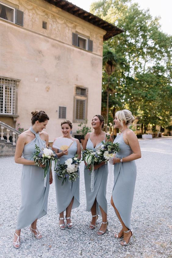 mismatching pale blue midi bridesmaid dresses and silver shoes are a nice combo for a modern wedding in spring or summer