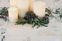 pillar candles with berries are a beautiful and affordable wedding centerpiece for fall or winter