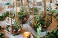terrariums with greenery, air plants and succulents plus candles and greenery around is a trendy idea