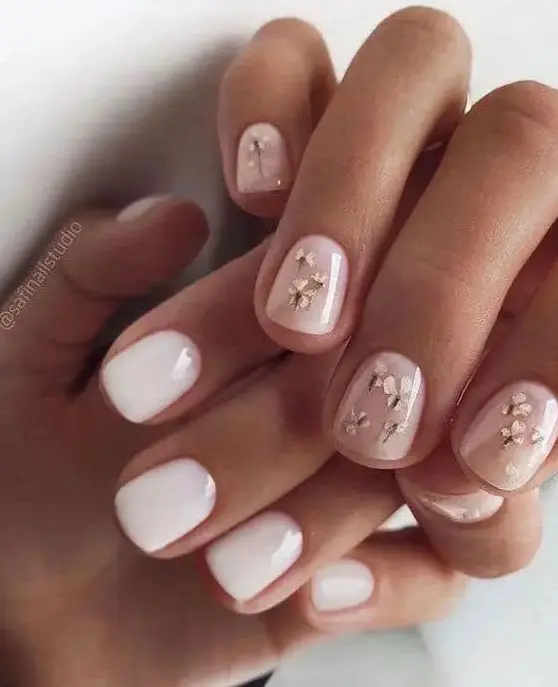 white and nude neails with little gold flowers is a stylish and beautiful spring wedding manicure you can try