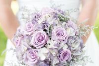 a beautiful lilac and lavender colored wedding bouquet with some pale greenery