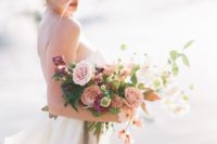 a beautiful pink and purple wedidng bouquet dotted with white blooms and greenery