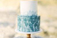 a bright and simple beach wedding cake with a white and watercolro teal tier and no other detailing is amazing