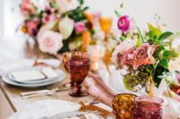 a chic summer wedding tablescape with printed plates, elegant pink blooms, pink and amber glasses and silver cutlery