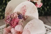 a double cake top forward wedding cake in neutrals with watercolors, with pink, purple and blush blooms for a refined spring or summer wedding