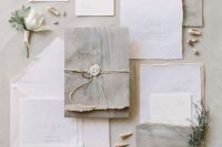 a dreamy coastal or beach wedding invitation suite in white and grey, with watercolors, with twine and seals plus seashells for a lovely beachy touch