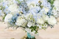 a dreamy wedding bouquet of light blue and white blooms plus a turquoise wrap is a cute idea