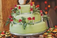 a fun woodland wedding cake in green, with sugar foliage and mushrooms plus funny snail toppers