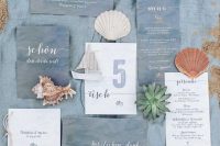 a lovely beach wedding invitaiton suite in slate blue and white, with blue and white calligraphy and sea-inspired prints