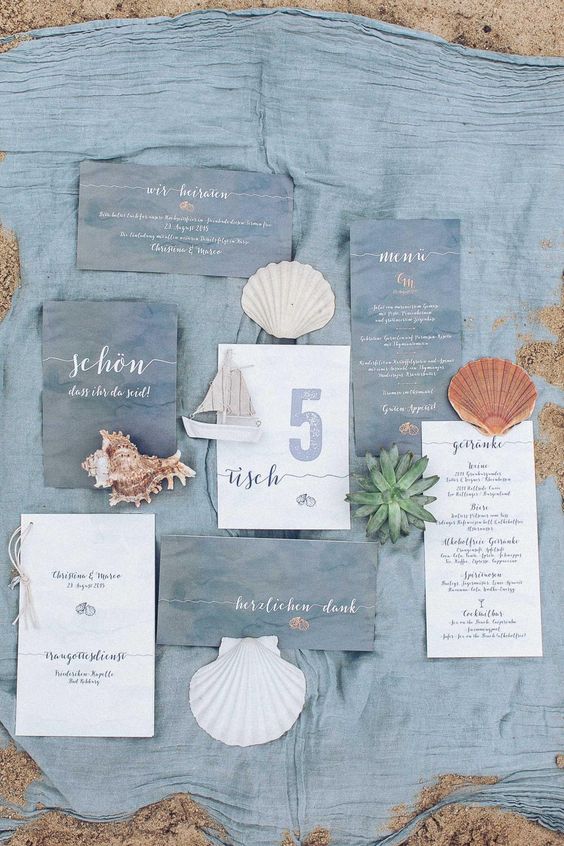 a lovely beach wedding invitaiton suite in slate blue and white, with blue and white calligraphy and sea-inspired prints