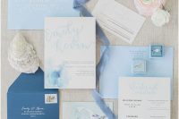 a lovely blue wedding invitation suite with light blue envelopes, a navy one, watercolor blue invites and RSVP