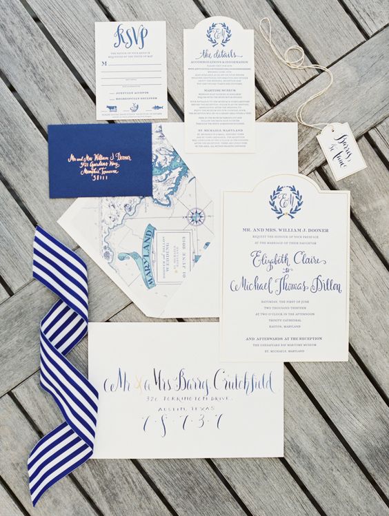 a lovely nautical wedding invitation suite with calligraphy, with gold foil letters and lovely sea maps and numbers is contrasting and cool