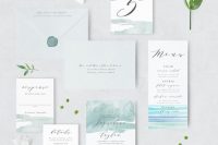 a lovely wedding invitation suite with light grey envelopes, invites with light green, blue and turquoise stripes is wow