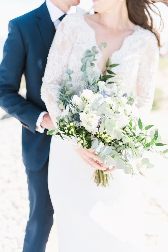 a neutral wedding bouquet of white and blue flowers, pale greenery and usual greenery