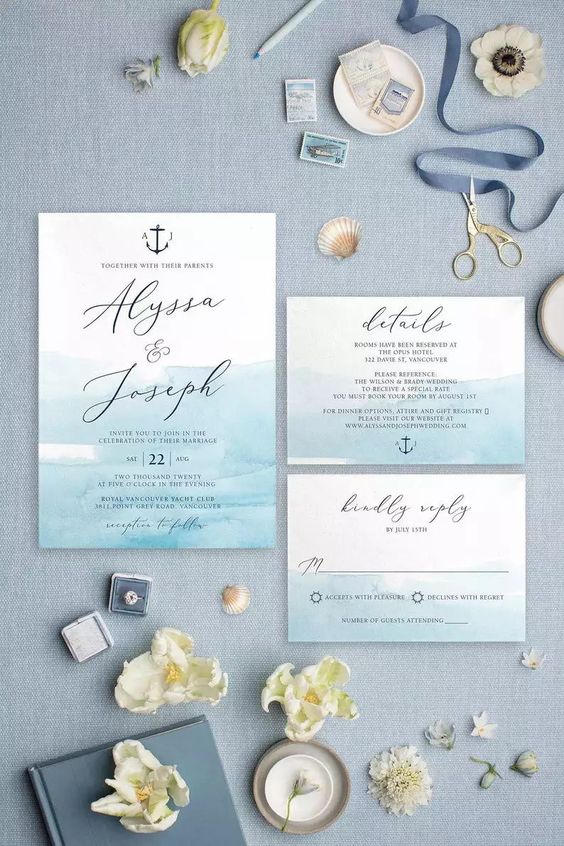 a pretty and bold wedding invitation suite with bold turquoise and white pieces, black calligraphy and anchor prints is wow