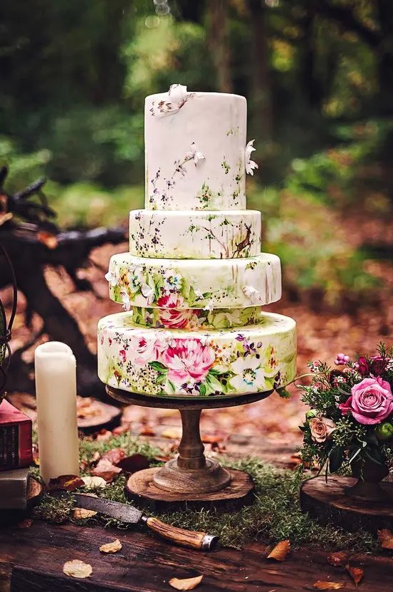 a quirky five tier floral wedding cake that shows off beautiful painting and some sugar blooms is amazing and adorable