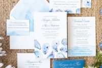 a seaside wedding invitation suite with gorgeous blue watercolors and oyster prints, with blue and white calligraphy