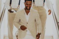 a tan suit, a white shirt and white pants to look chic and stylish on your beach wedding day