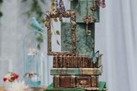 a unique square wedding cake with moss, mushrooms, books, butterflies and fresh and sugar blooms and frames just wows