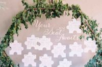 a unique wedding seating chart with lush greenery, blush blooms and a puzzle piece plan