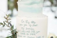 a white and blue marble wedding cake with a raw edge, fresh neutral and blush blooms and greenery for a spring wedding