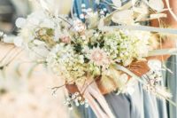 an ethereal and textural wedding bouquet with pastel and neutral blooms and dried touches