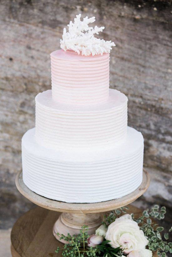 an ombre pink textural wedding cake with a coral on top is a chic and bright idea for a modern coastal or beach wedding