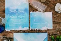 bright blue and turquoise seaside-inspired wedding invitations with a raw edge and white seals are amazing for a bold beach wedding