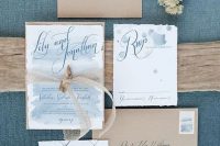 ethereal blue watercolor wedding invies with a raw edge and kraft paper envelopes are great for a coastal or beach wedding